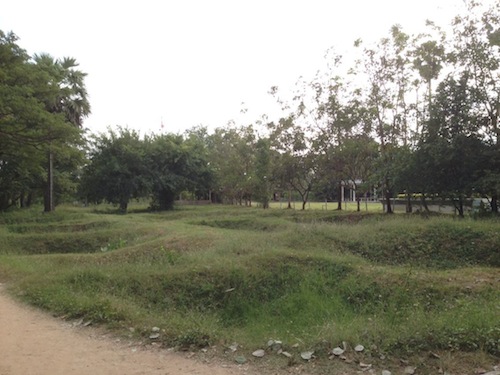 Mass graves at Choeung Ek where large number of bodies are still buried so shallow that bones and clothing surface after heavy rainfalls even till today